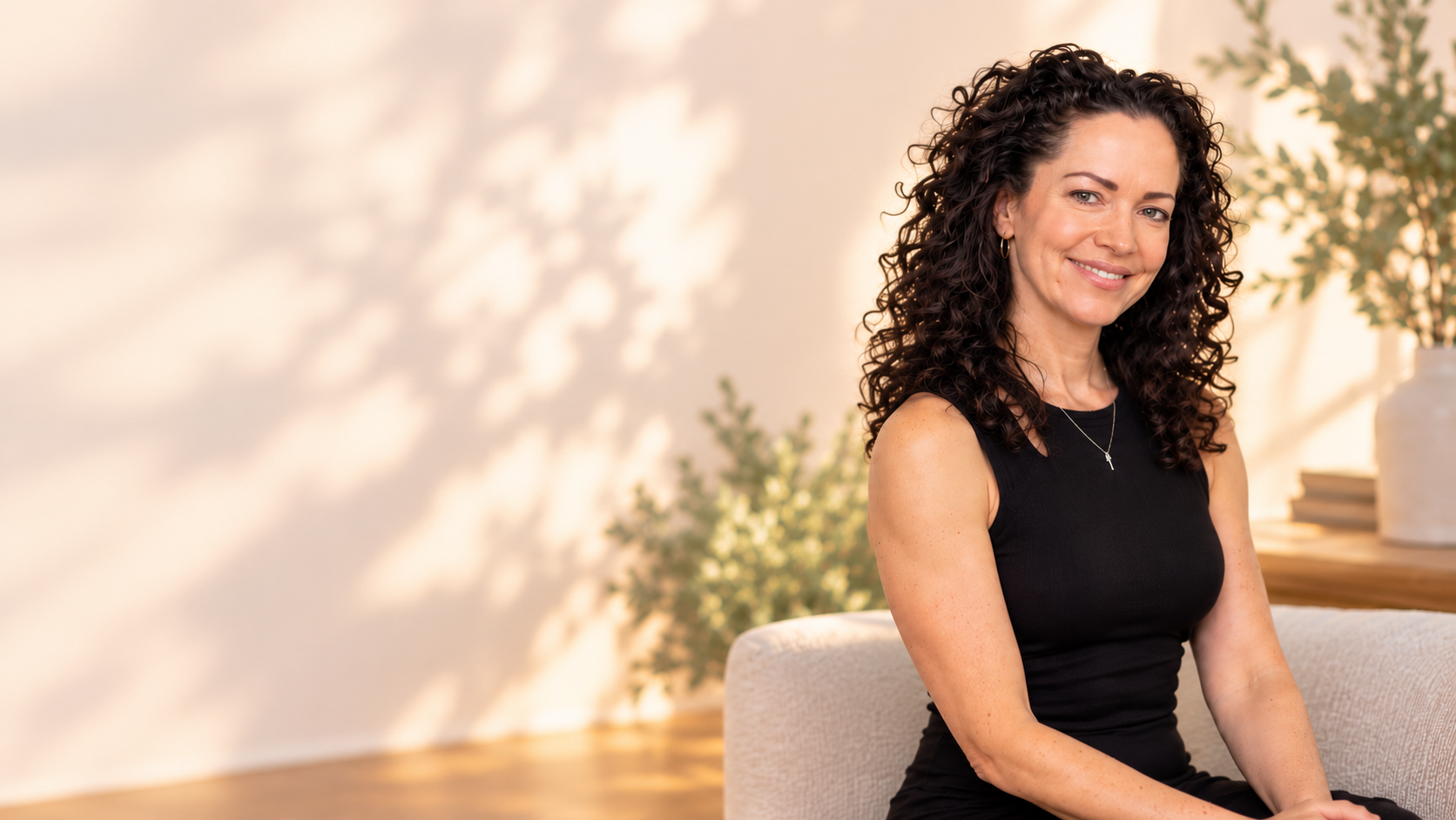 Sunny Kallmer smiling in a warm, softly lit setting